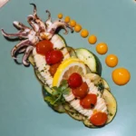 Pan-fried baby squid with garlic, herbs, and cherry tomatoes served at KAIO Beach Front Restaurant.