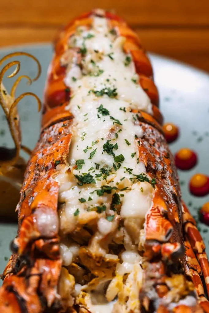 Close-up baked lobster thermidor with parmesan crust and saffron beurre monté at KAIO Beach Front.