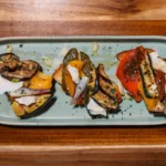 Toasted bruschetta topped with grilled vegetables and shaved Parmesan at KAIO Beach Front.
